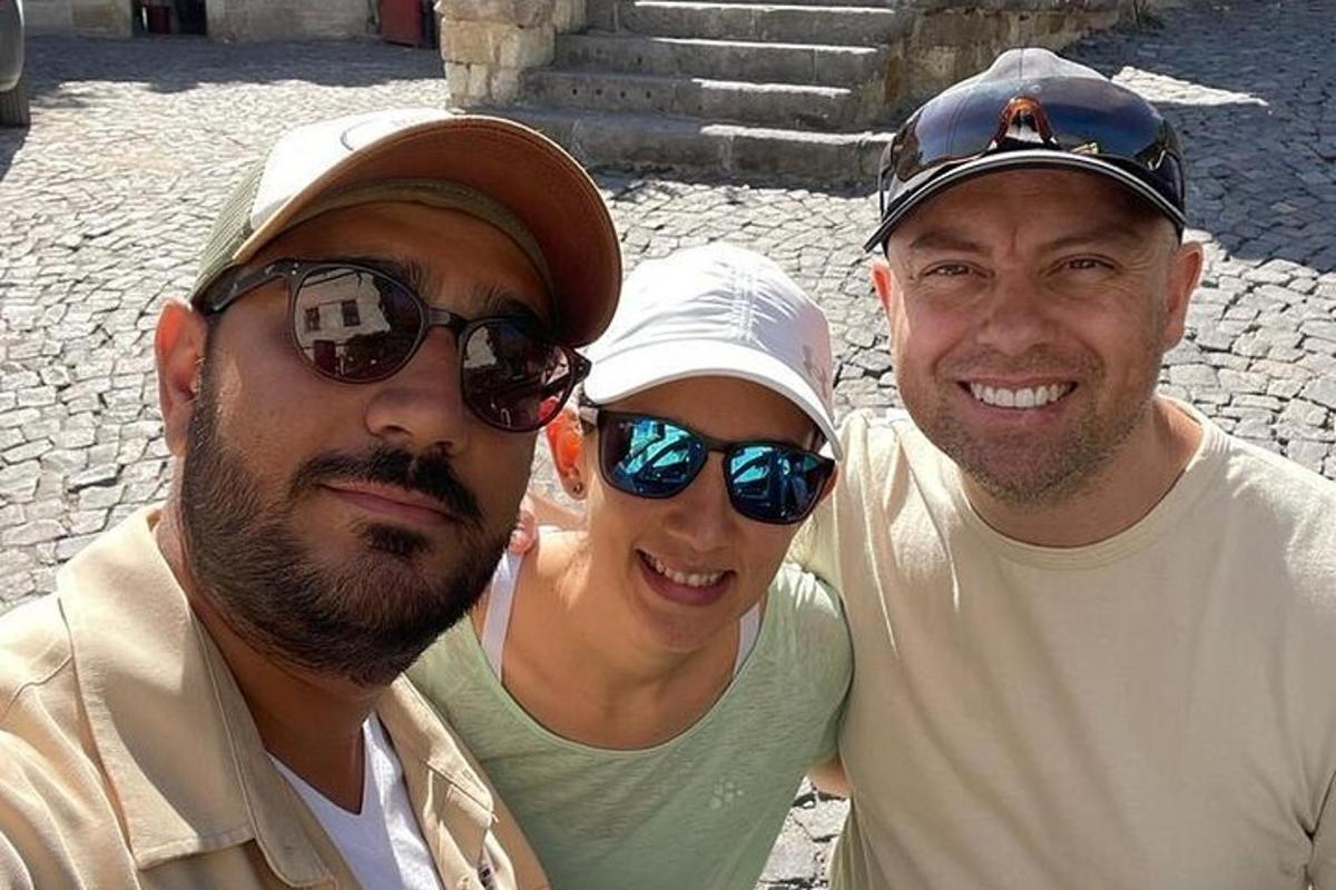 two men and a woman posing for a picture