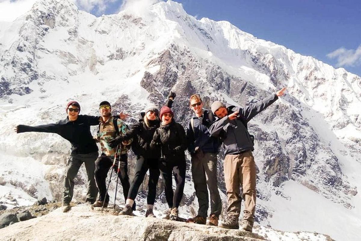 a group of people standing on top of a mountain