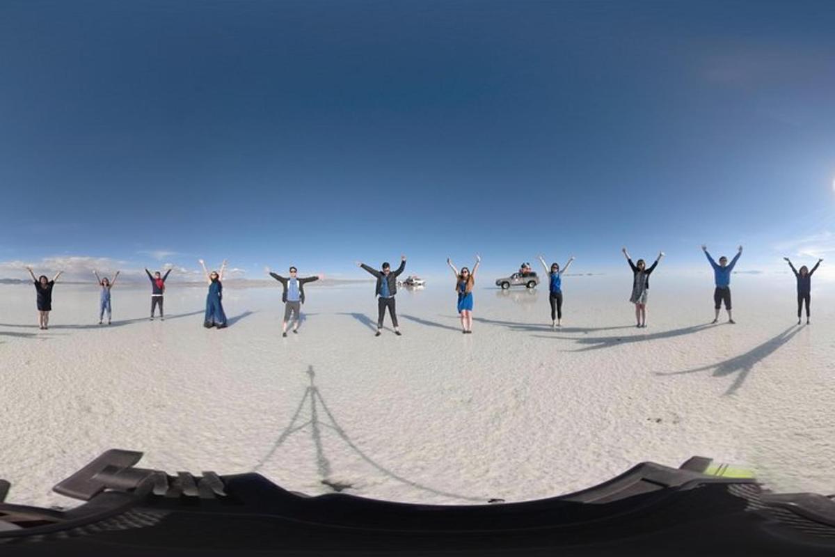 a group of people dancing on the beach