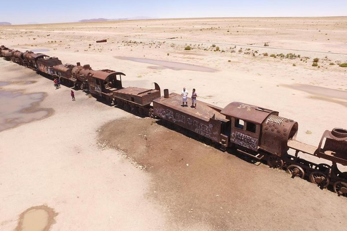 an old train in the middle of the desert