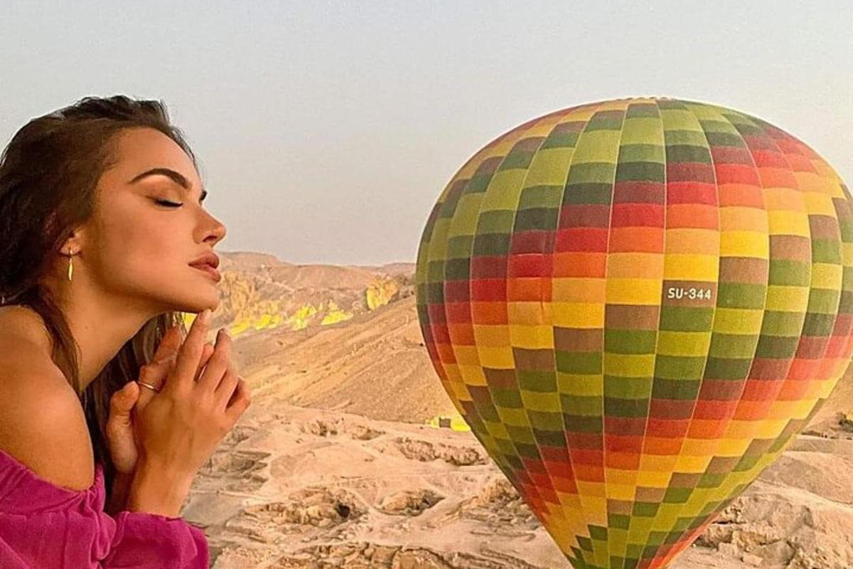 a woman looking at a hot air balloon