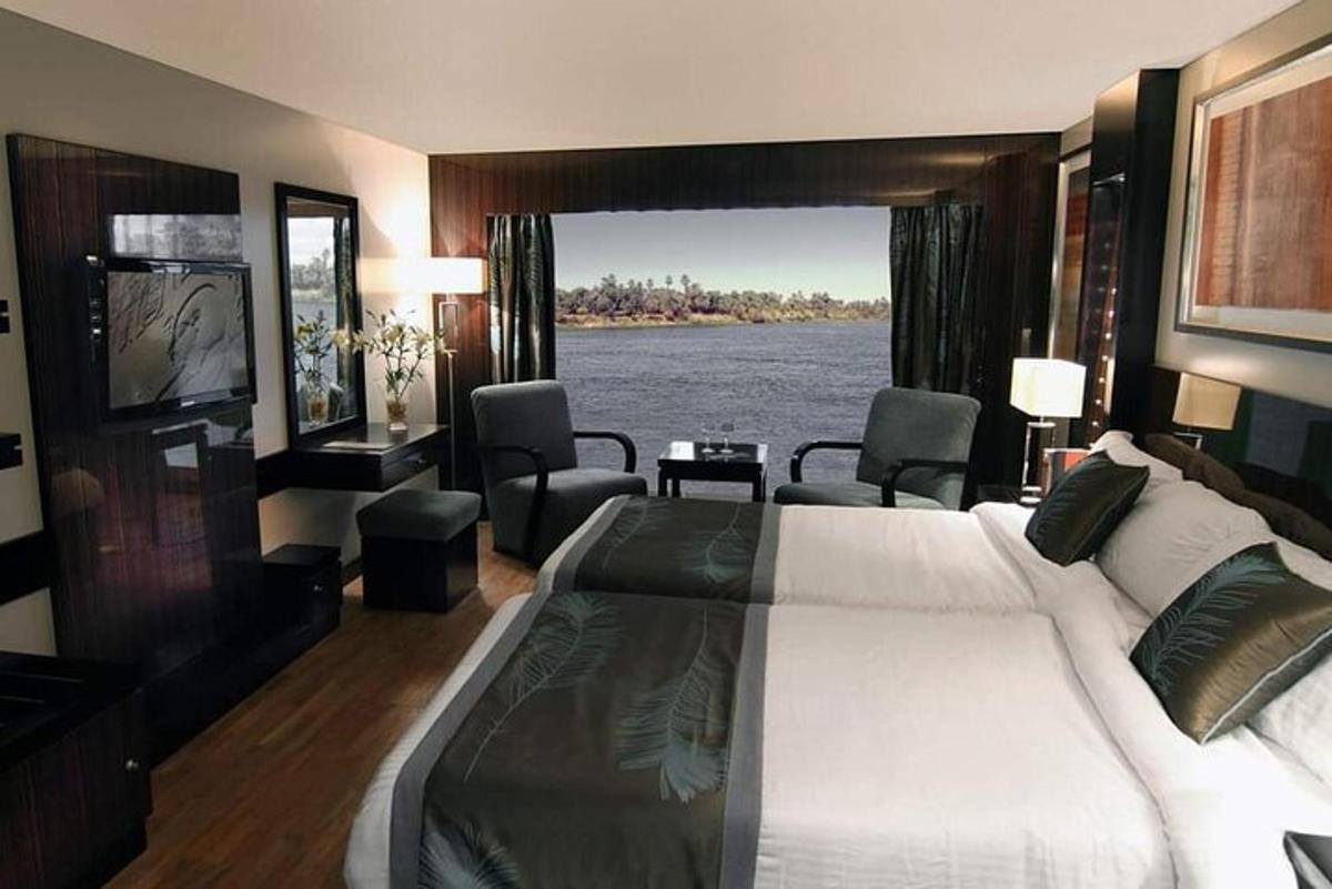 a bedroom with a bed and a view of the water