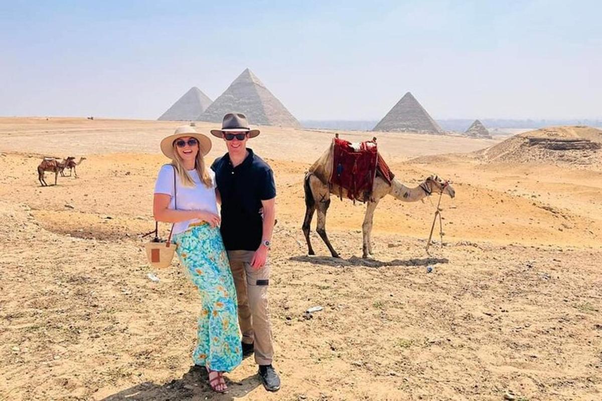 a man and a woman standing in front of pyramids