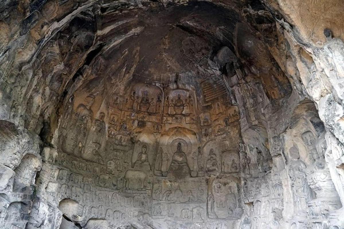 a cave with carvings on the side of it