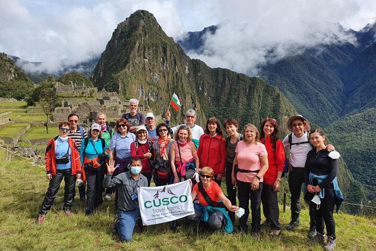 a group of people posing for a picture on a mountain