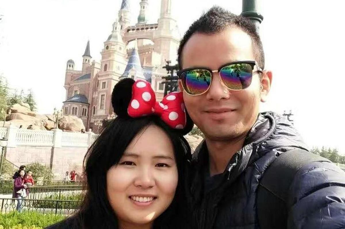 a man and a woman posing in front of a castle