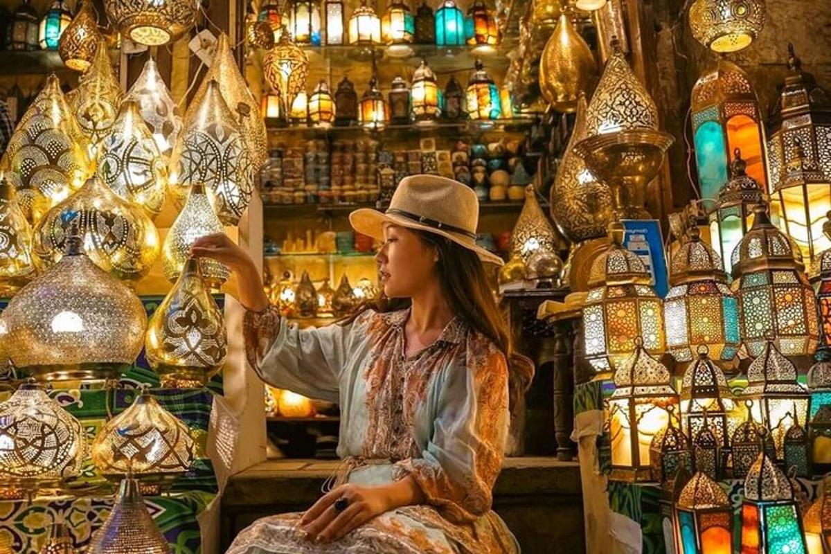 a woman in a hat sitting in a shop with lamps