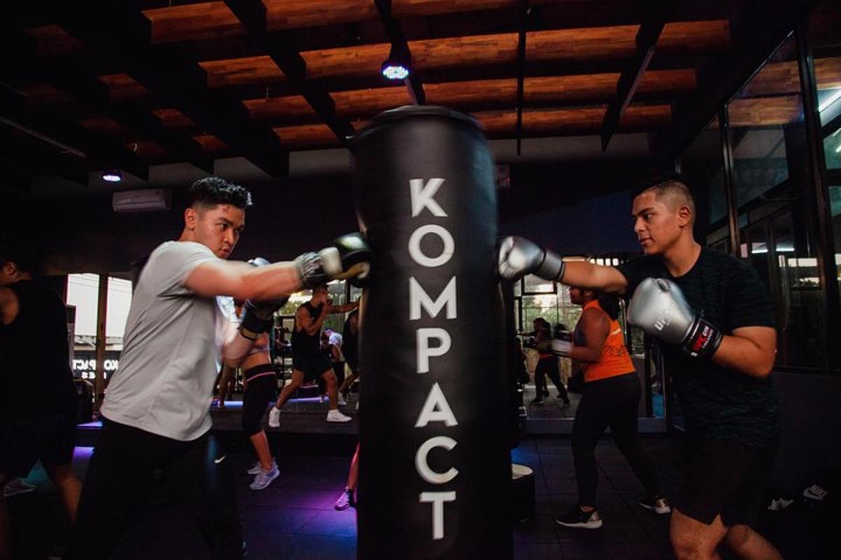 two men are boxing in a gym with a sign