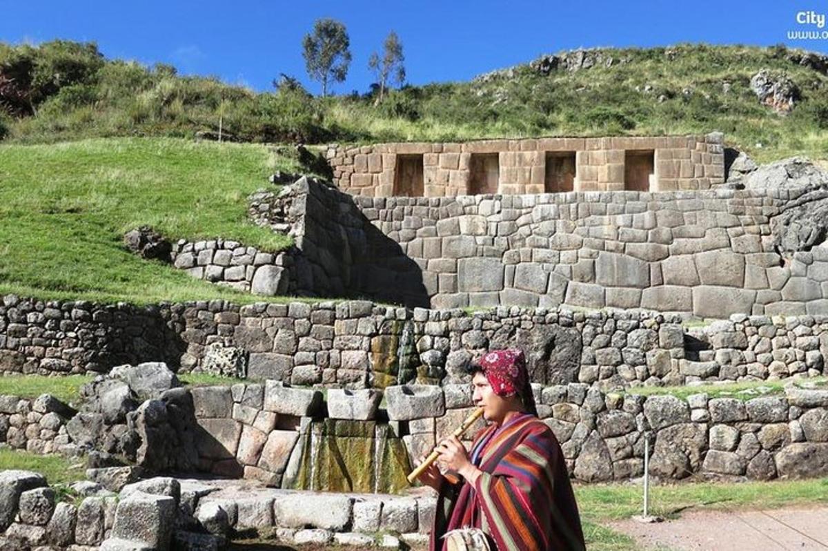 a woman walking in front of a stone wall