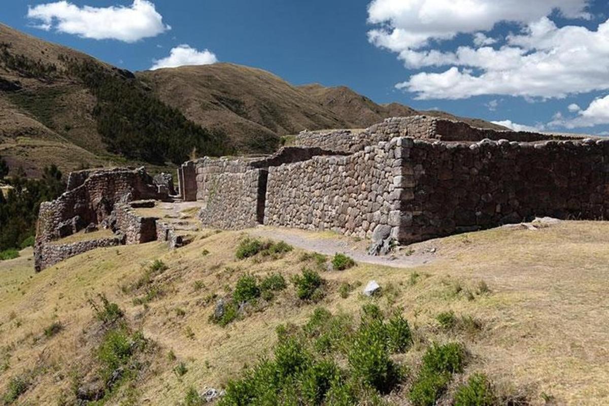 an old stone building on top of a hill