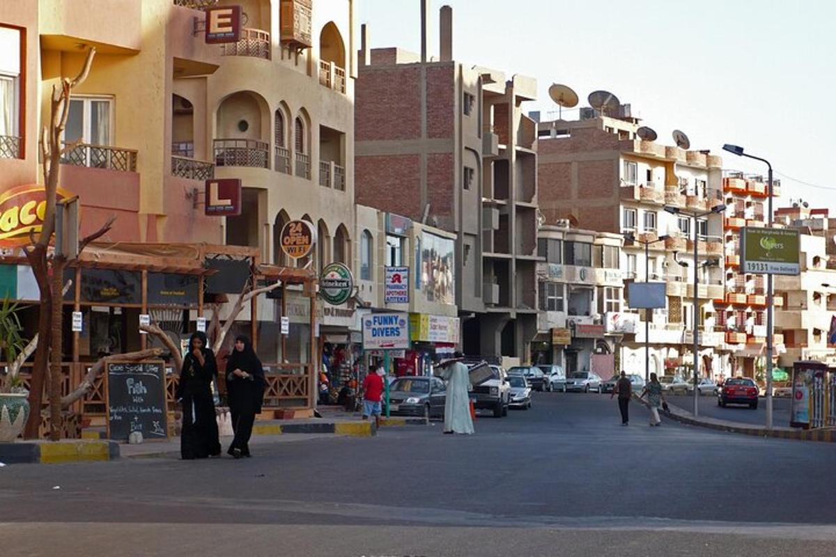 a city street with buildings and people walking on the street
