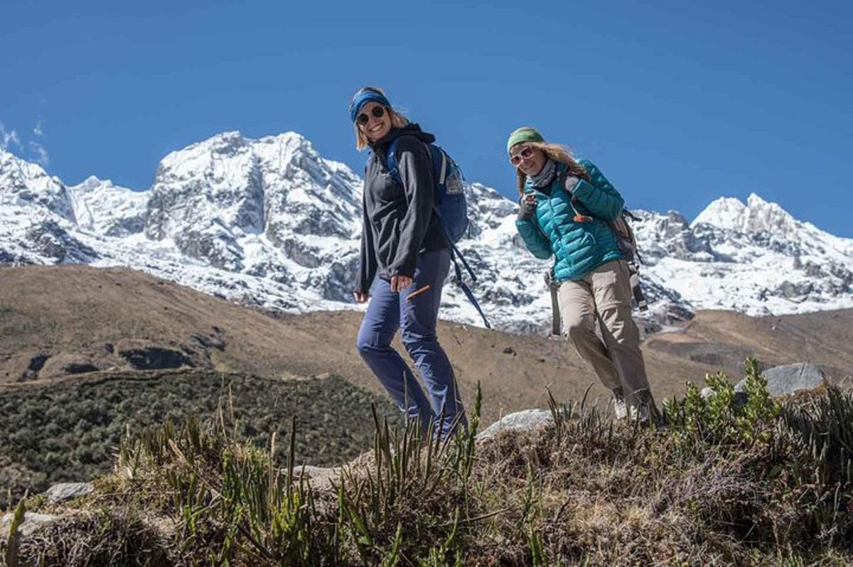 two people standing on top of a mountain
