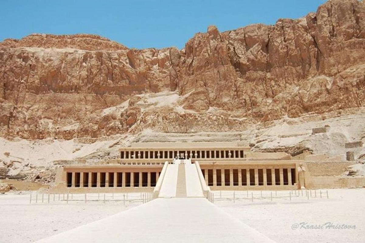 um edifício no meio de um deserto com uma montanha