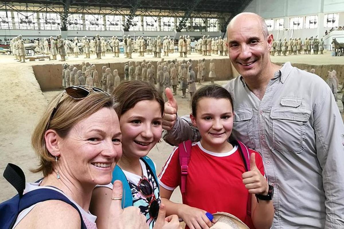 a family posing for a picture in front of a statue