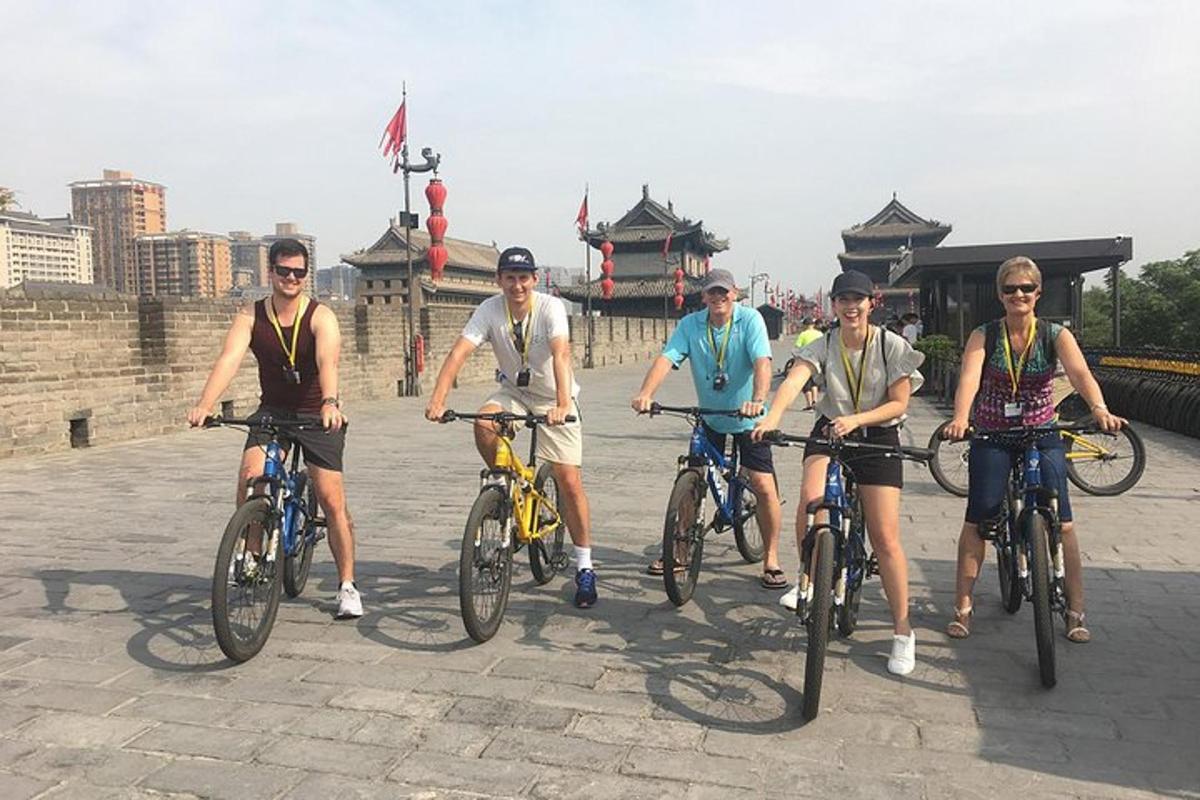 a group of people riding bikes on a bridge
