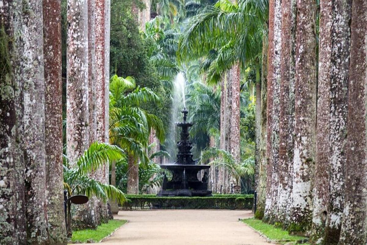 a fountain in a garden between two palm trees