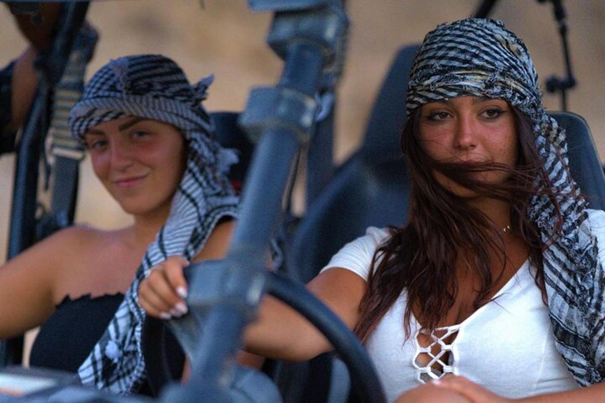 two women with long hair and a beard sitting