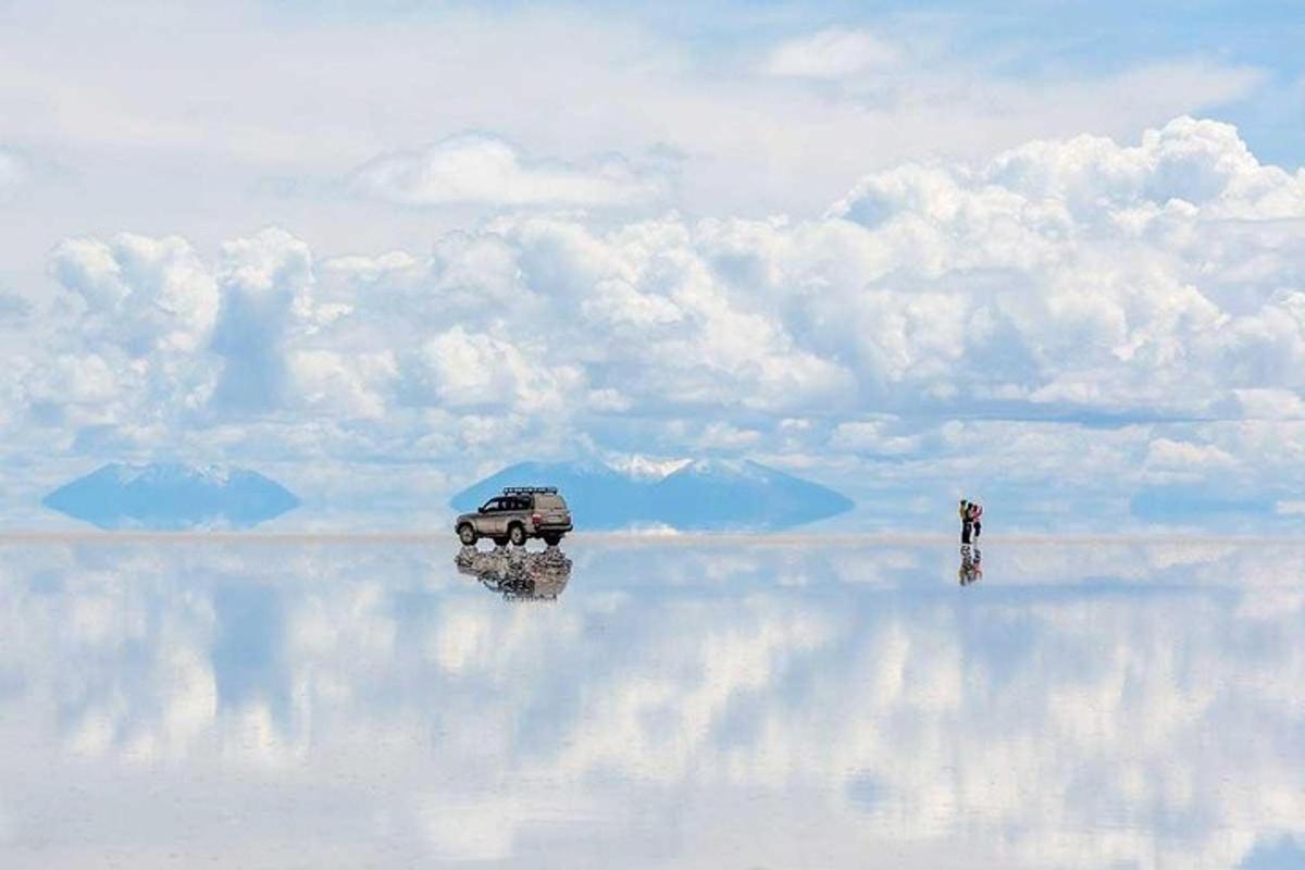 a reflection of a car on a body of water