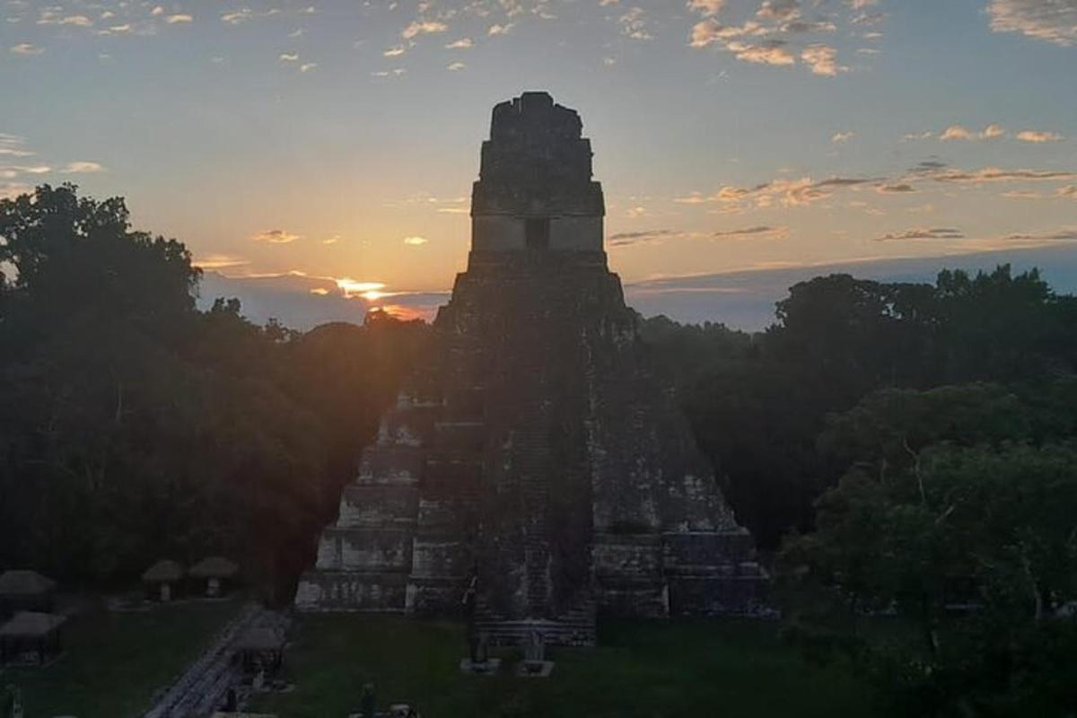 an image of the sun setting behind the temple