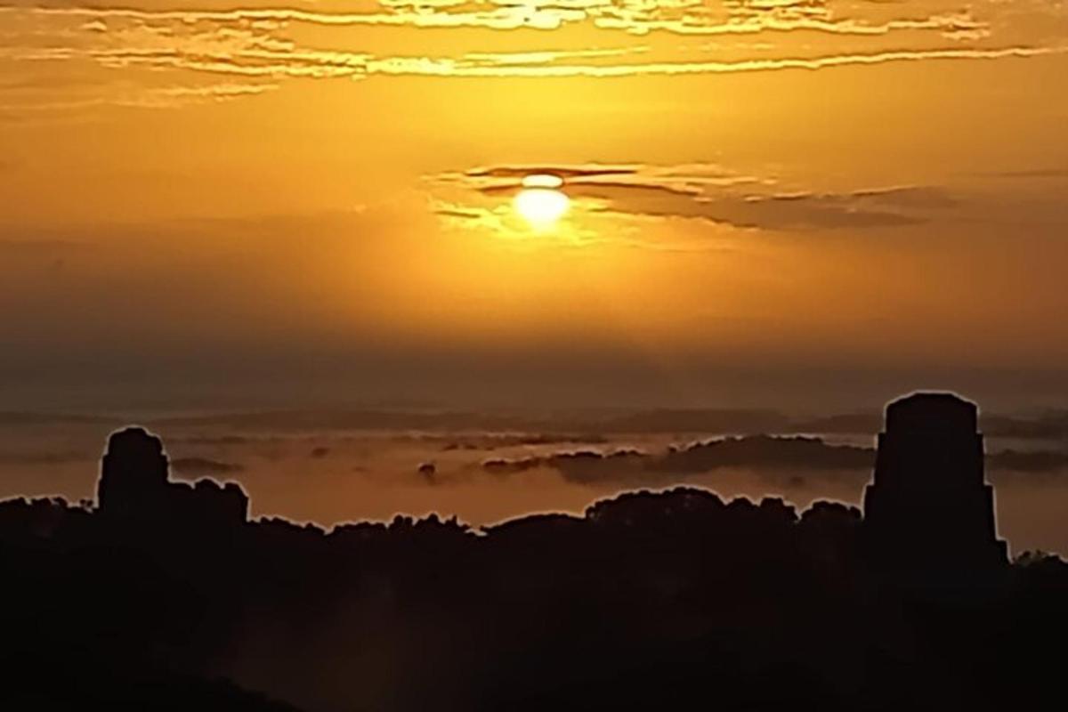 a sunset with the sun in the sky