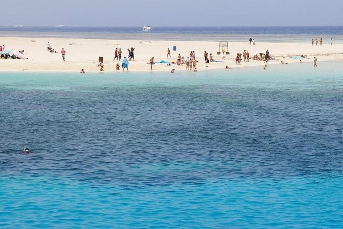 een groep mensen op een strand en het water