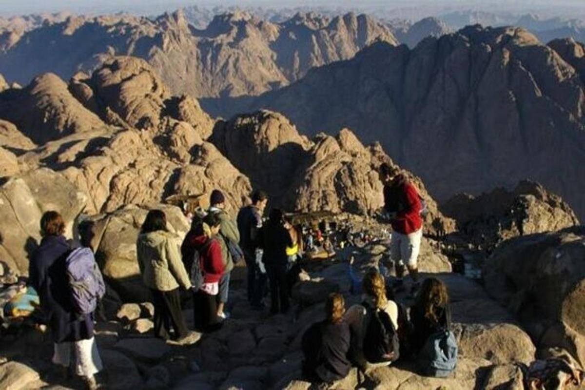 Un grupo de personas de pie en la cima de una montaña