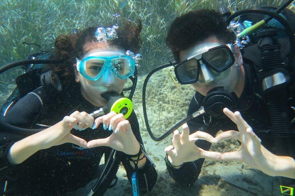 two people making a heart with their hands in the water