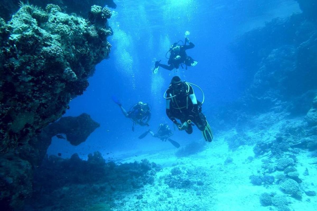 three people are scuba diving in the ocean