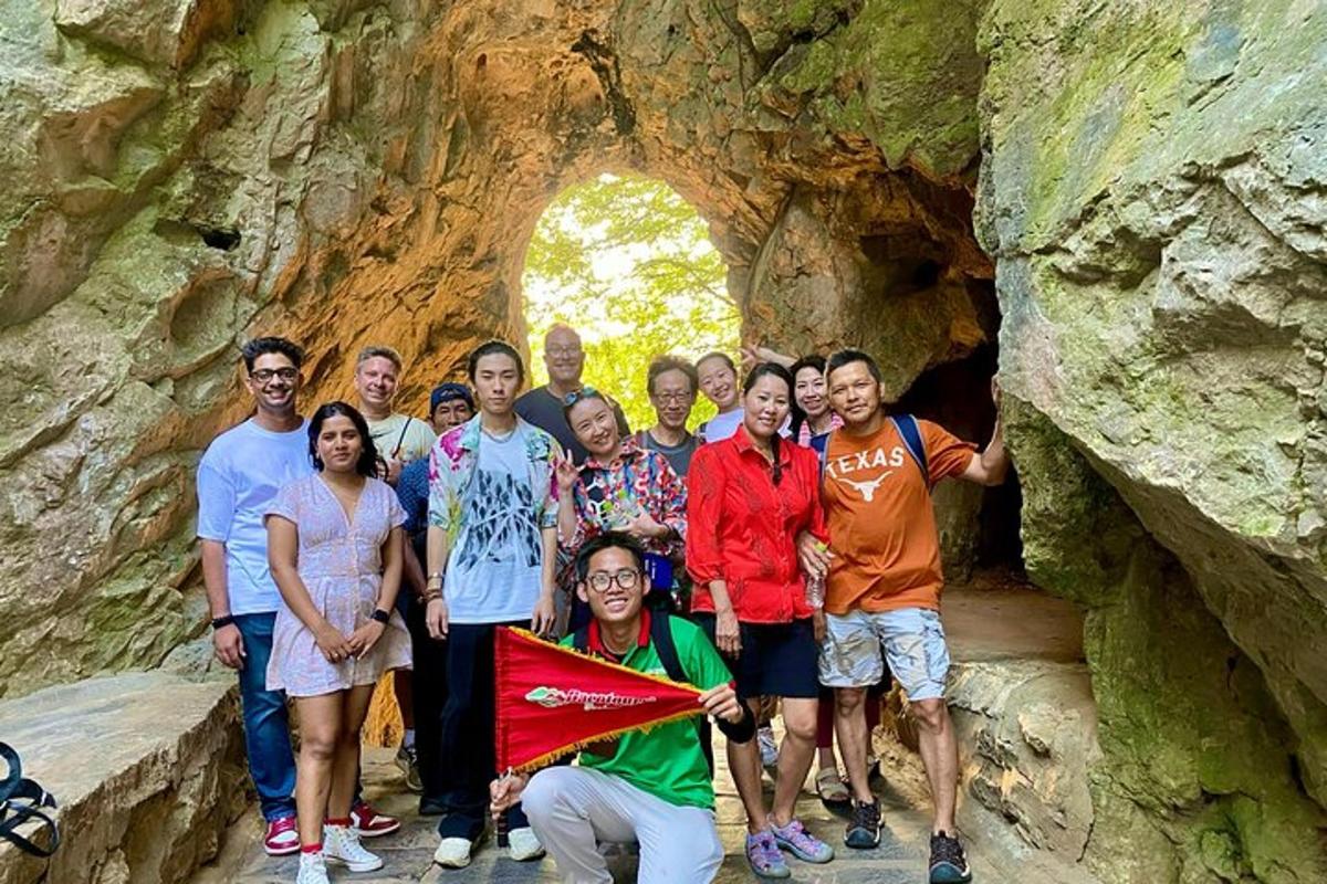 a group of people posing for a picture in a cave