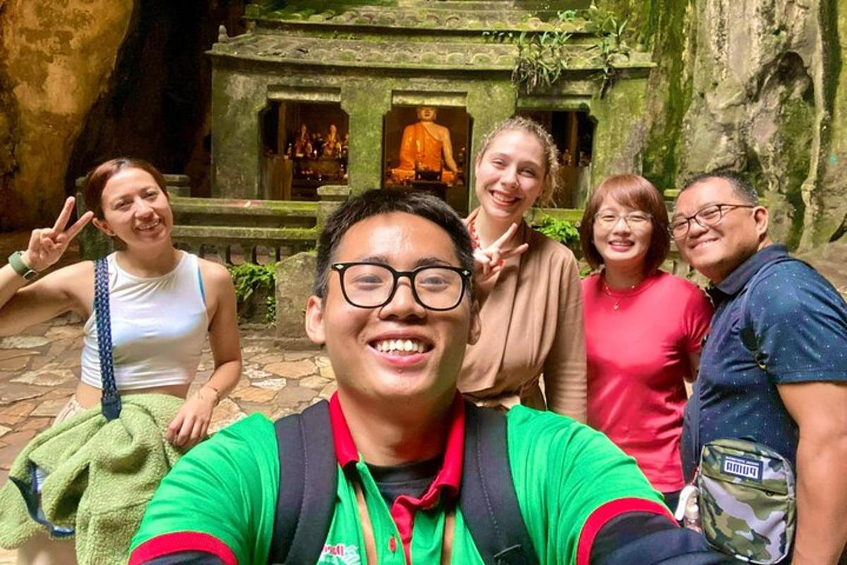 a group of people posing in front of a temple
