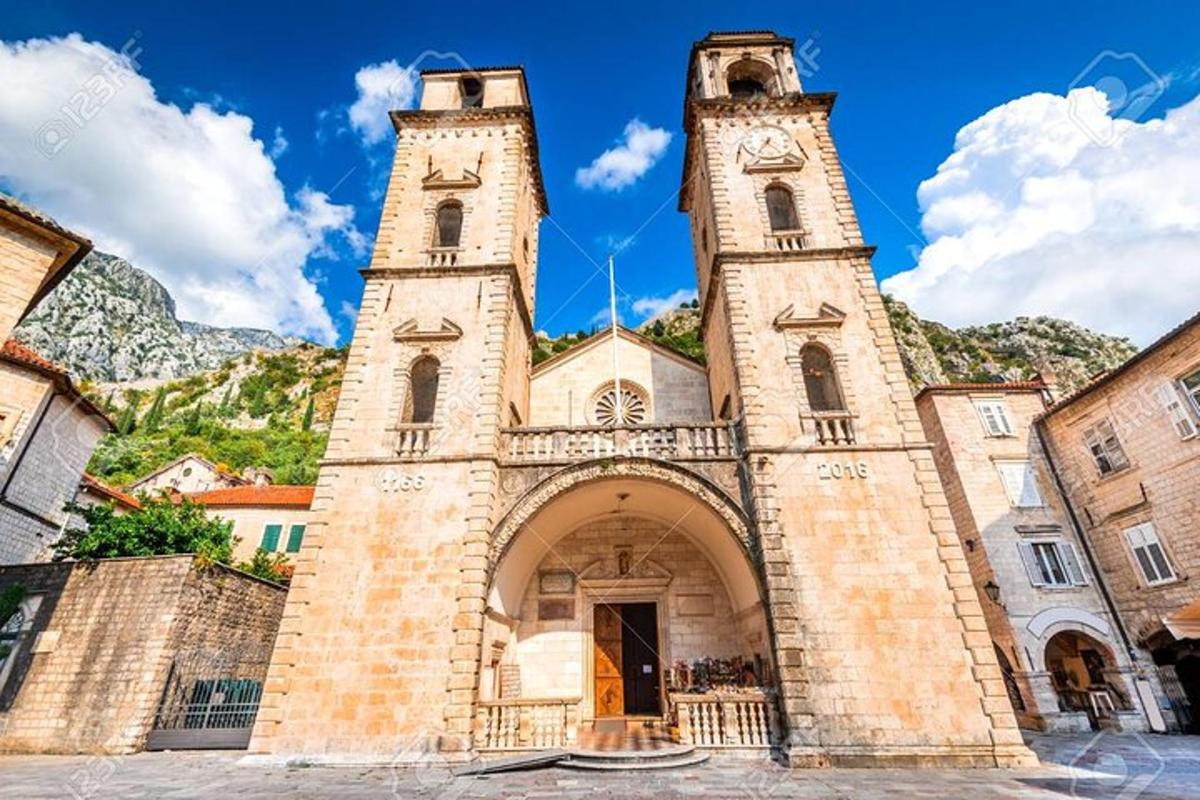 an old church with two towers on a street