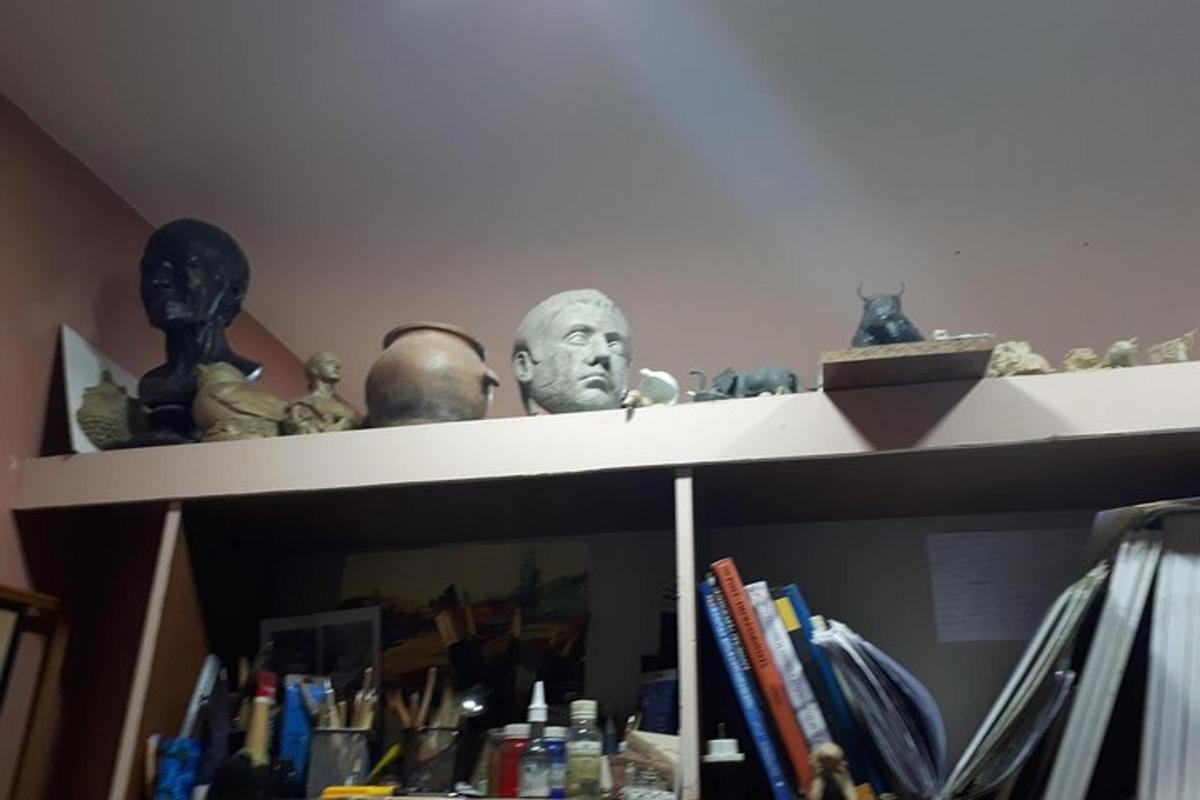 Un estante con un busto de un hombre en él