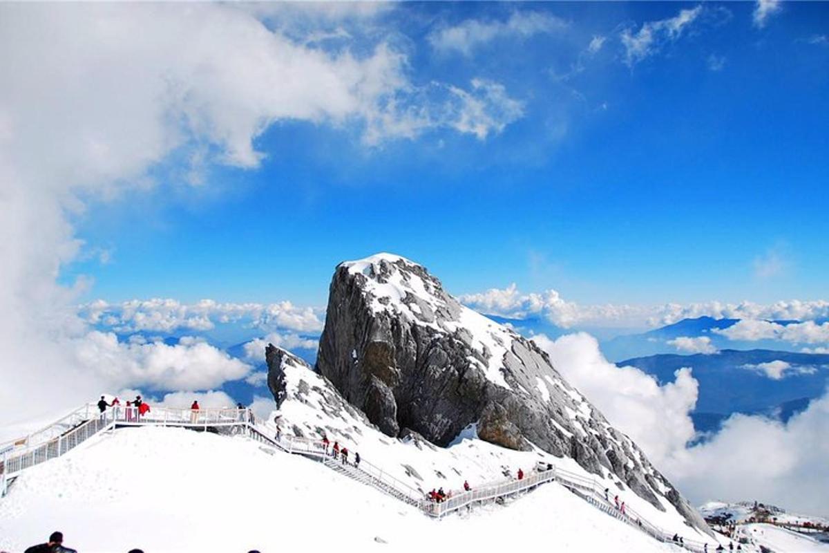 a group of people on top of a snow covered mountain