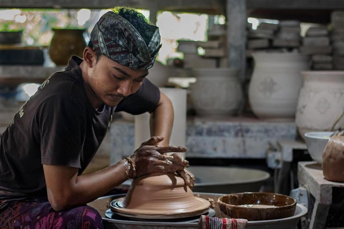 a man making a vase on a pottery wheel