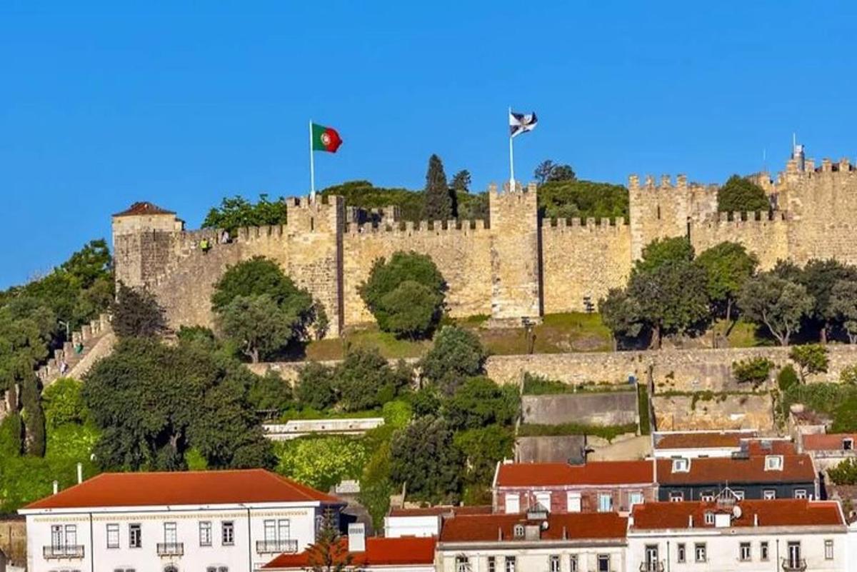 a castle with two flags on top of a city