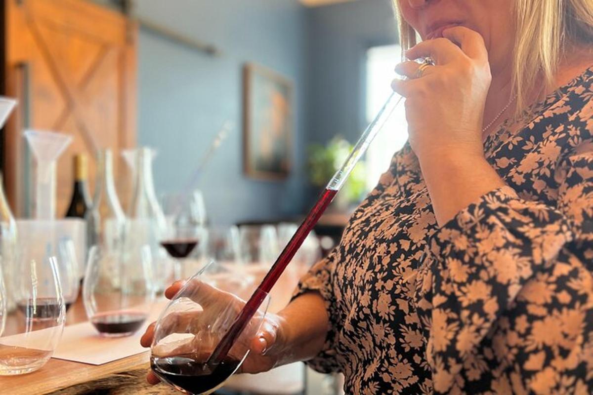 a woman talking on a cell phone while holding a glass of wine