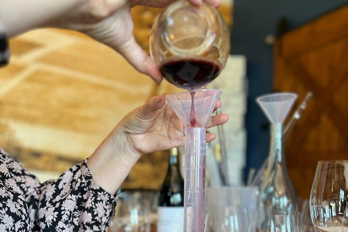 a woman is pouring wine into a glass