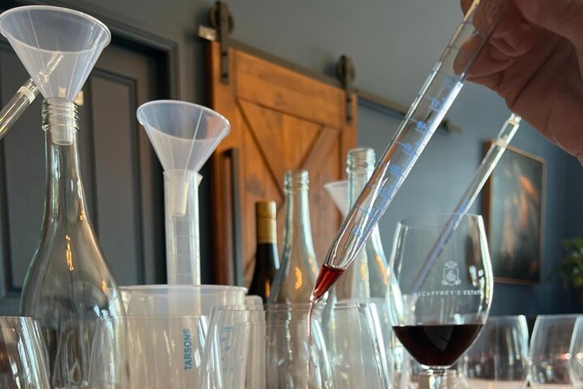 a person is pouring a glass of wine on a table