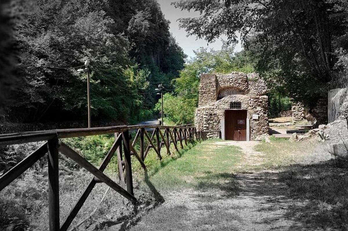 o clădire din piatră cu gard de lemn într-un câmp