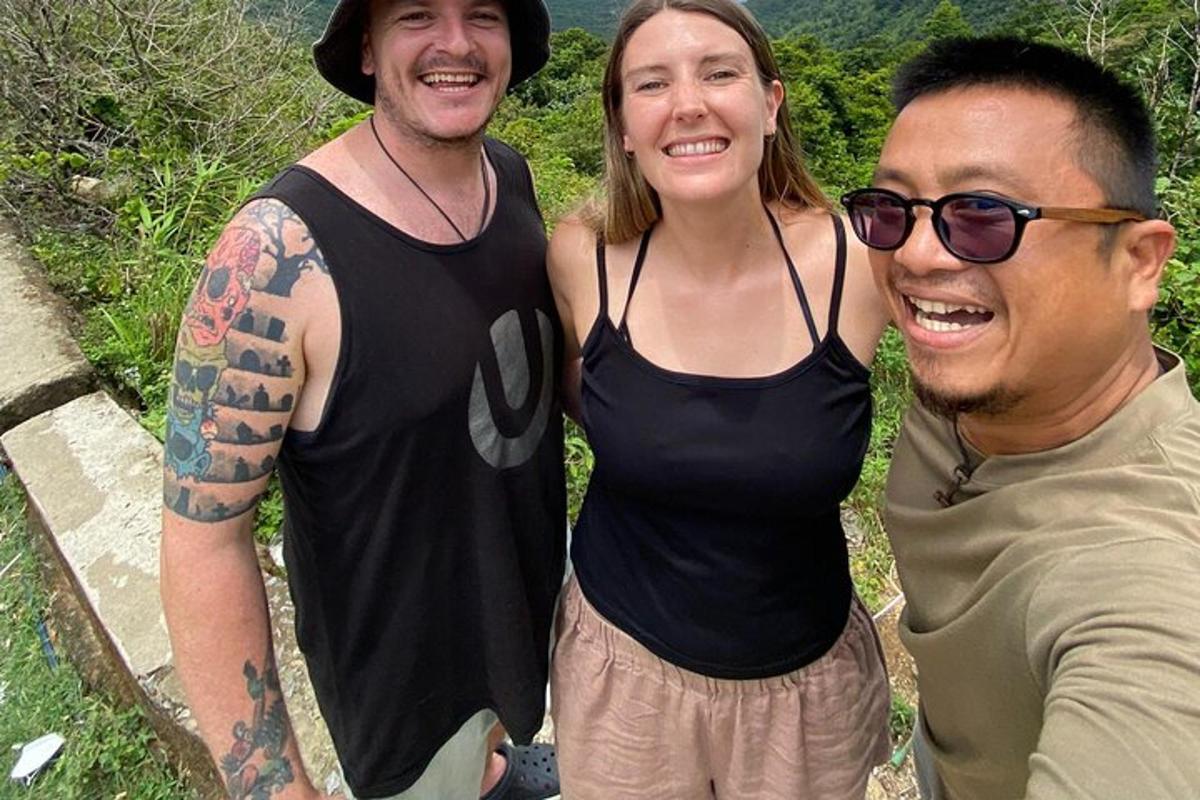two men and a woman posing for a picture