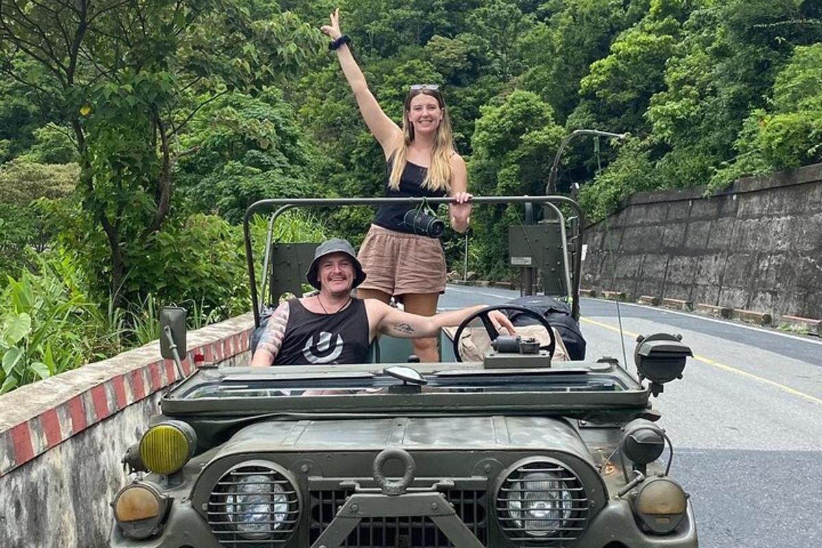 a man and a woman in an amphibious car on the road