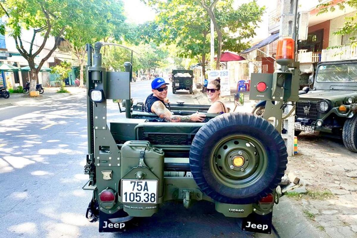 two men riding in a military jeep