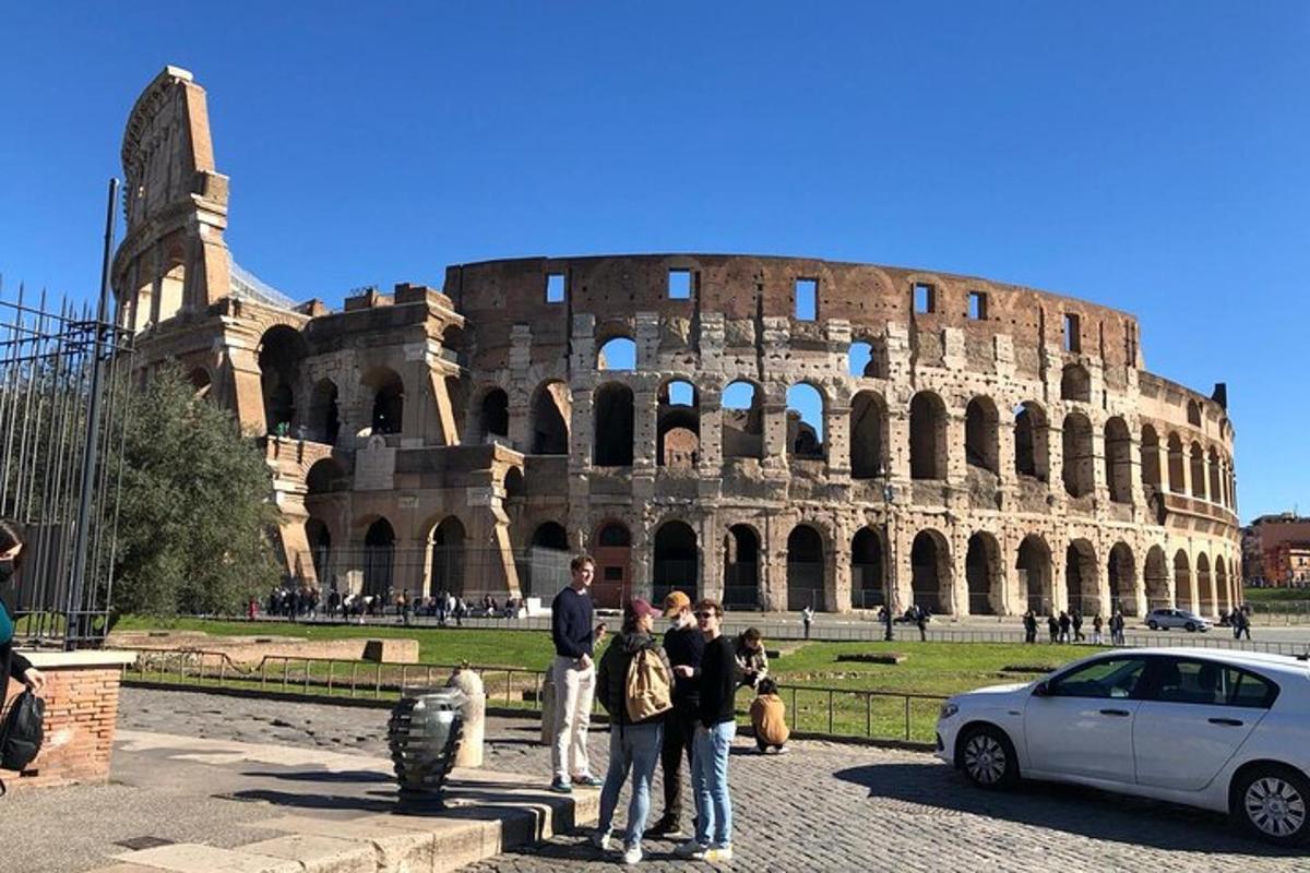 a group of people standing in front of the coliseum