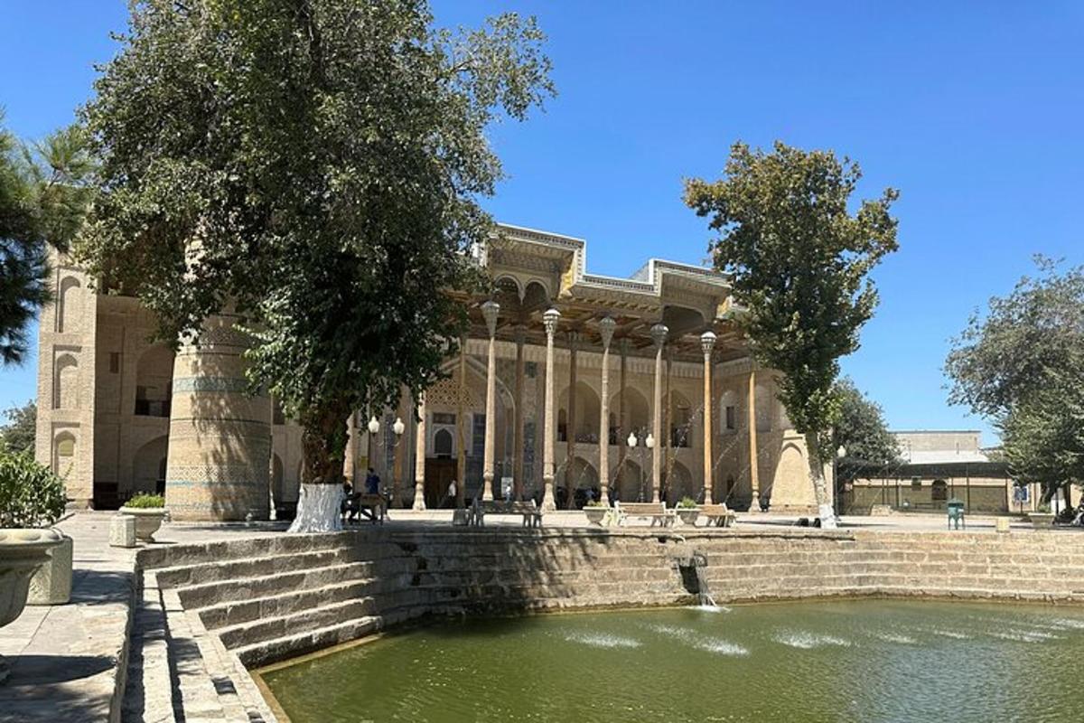 a large building with a pond in front of it