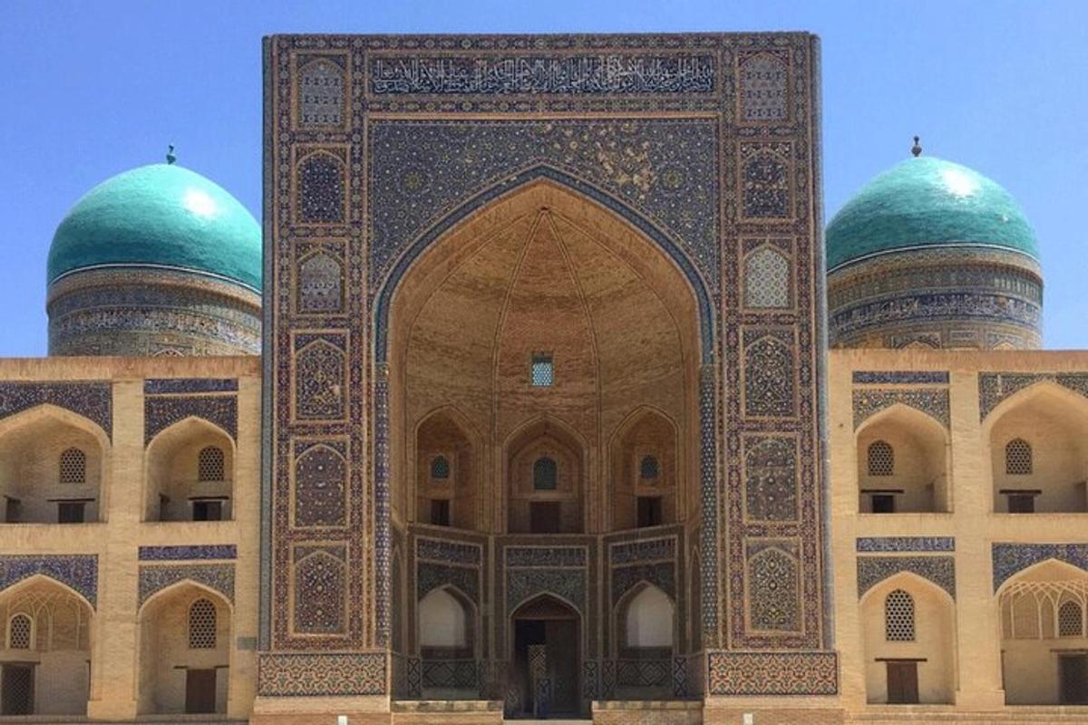 a large building with two green domes on it