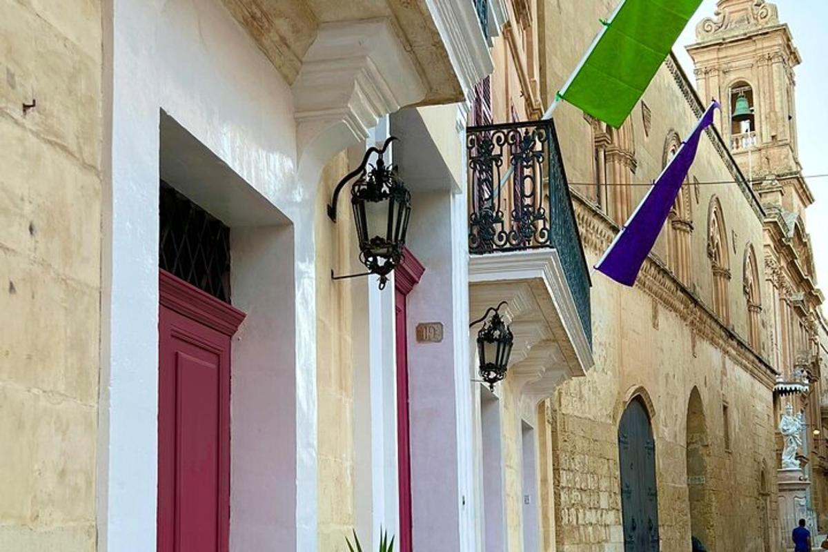 a building with a red door and flags on it