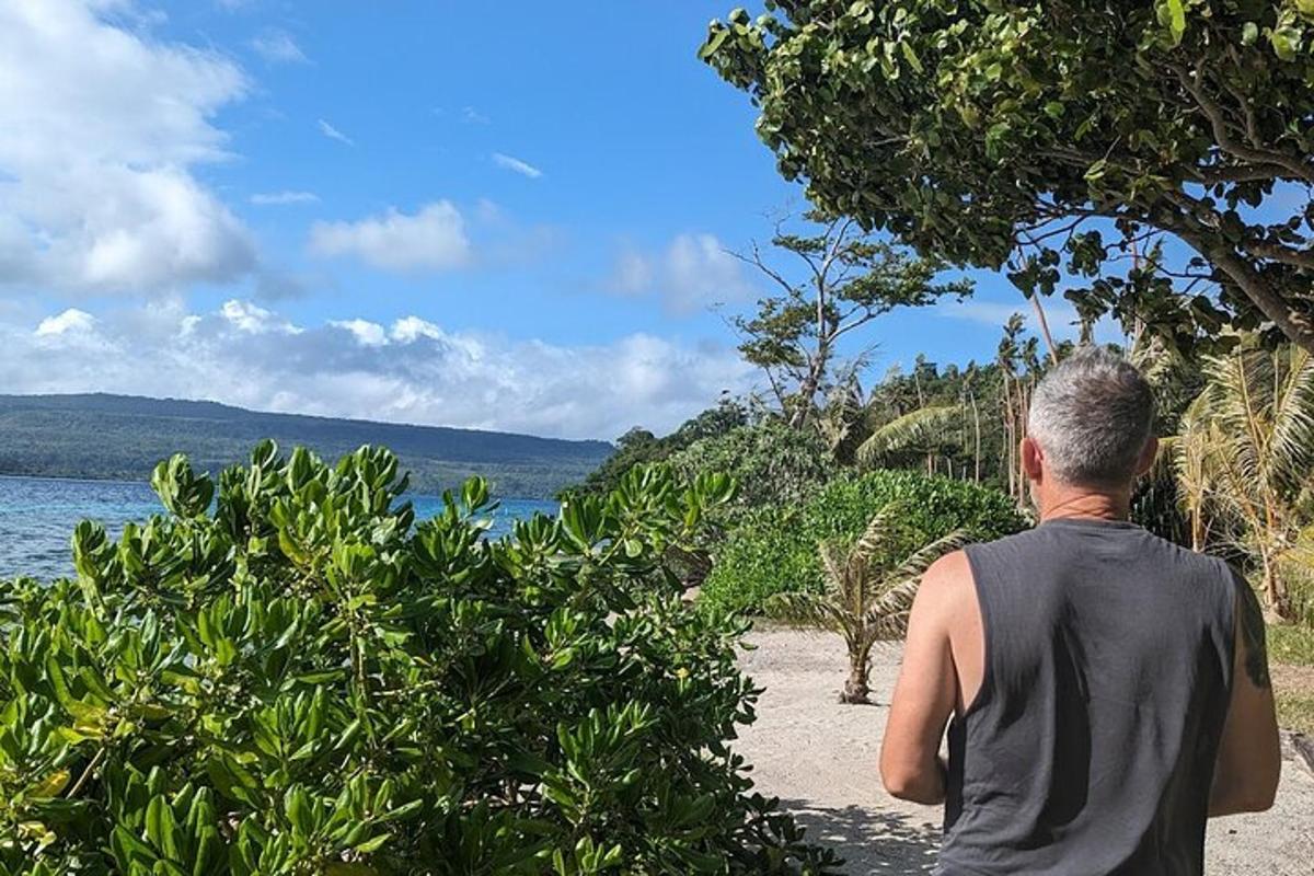 a man standing on a beach looking at the water