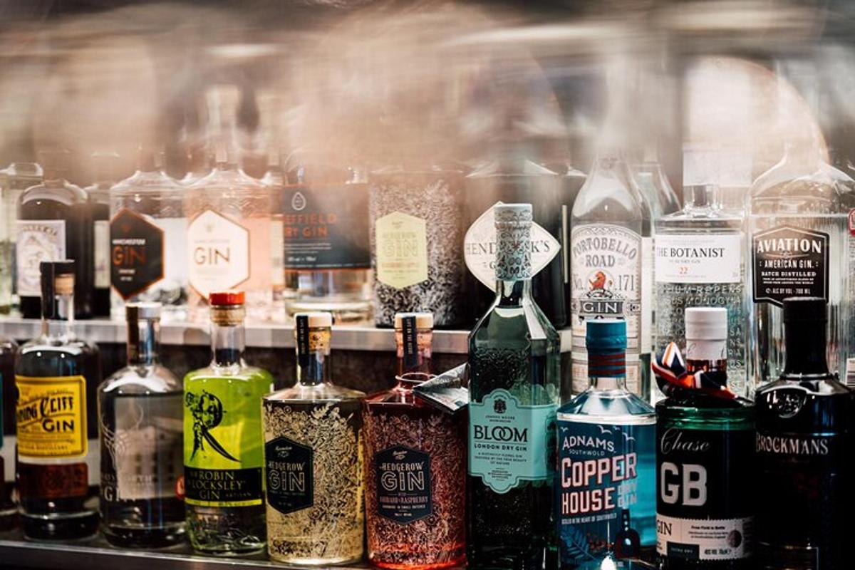 a bunch of bottles of alcohol on a shelf