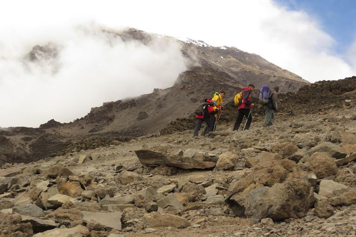 un gruppo di persone che camminano su una montagna rocciosa