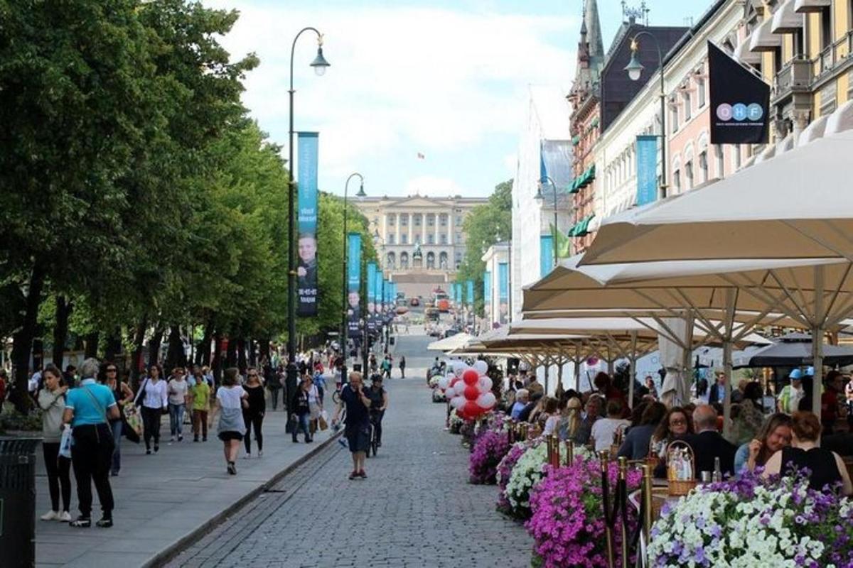 a crowd of people walking down a city street with flowers